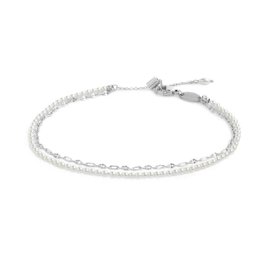 Cavigliera doppia catena con perle bianche e lip-cable